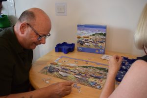 Russell and Nicky completing a jigsaw puzzle