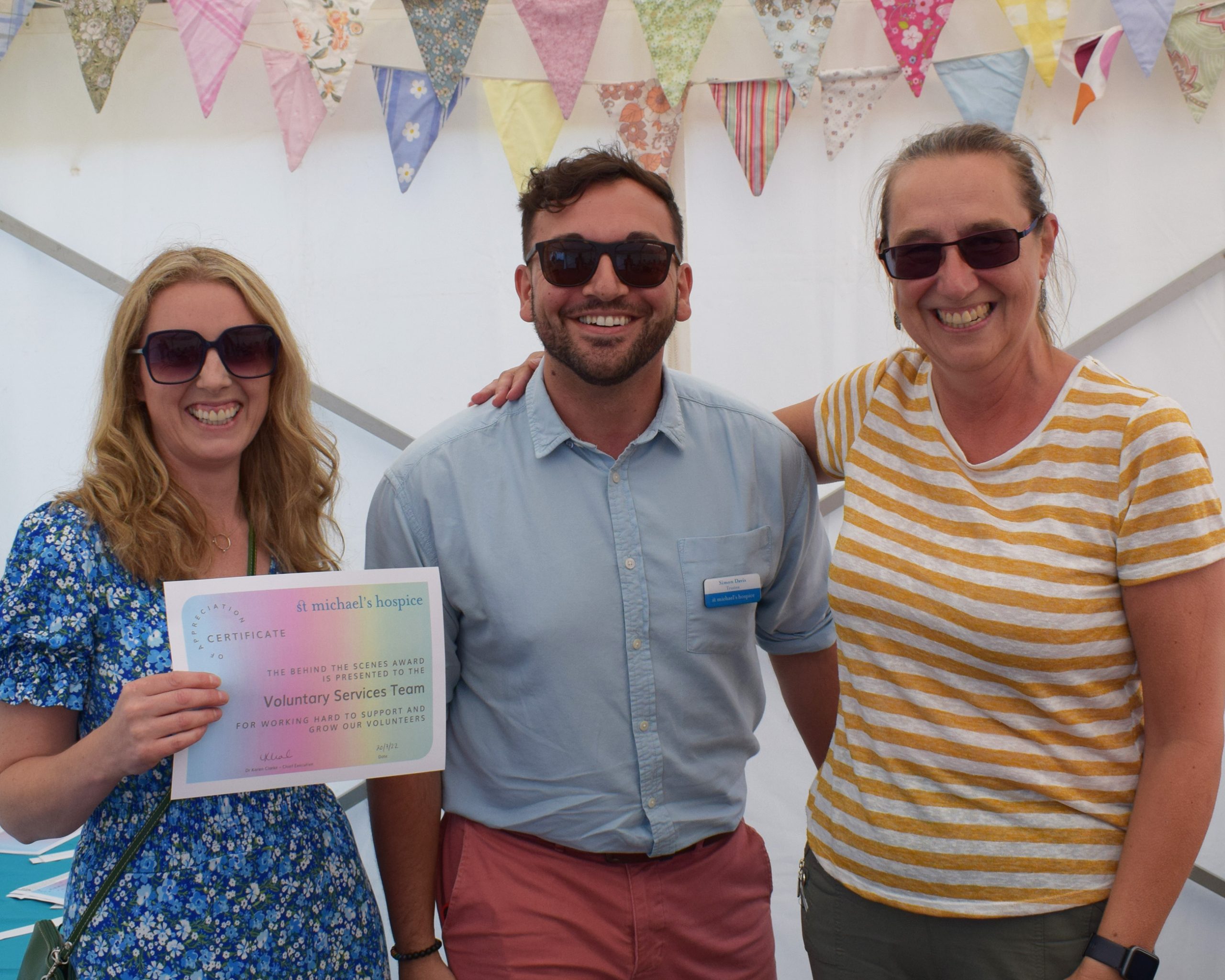Image showing our trustee Simon together with two Hospice staff at a volunteer's 'thank you tea', event.